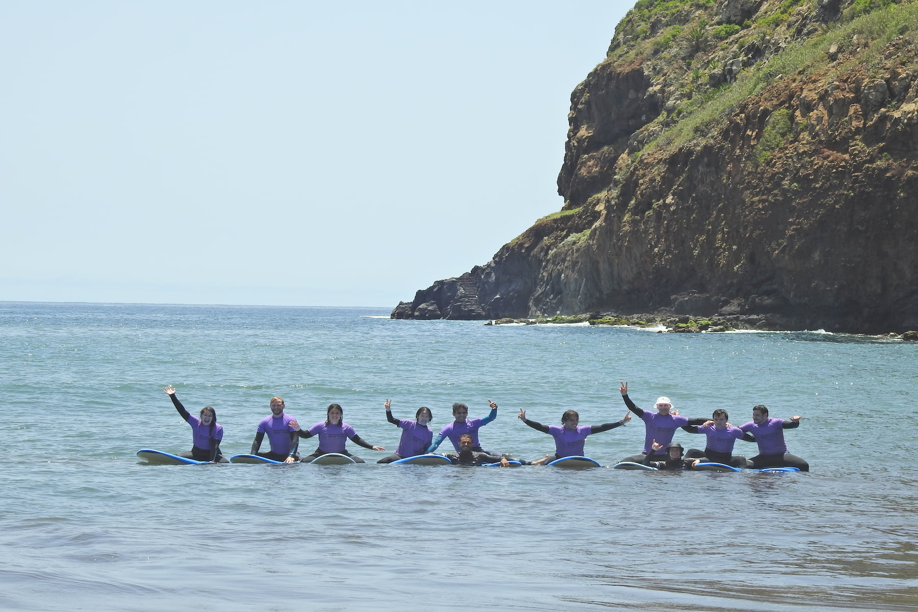 Group of surfers doing a group surf lesson in madeira