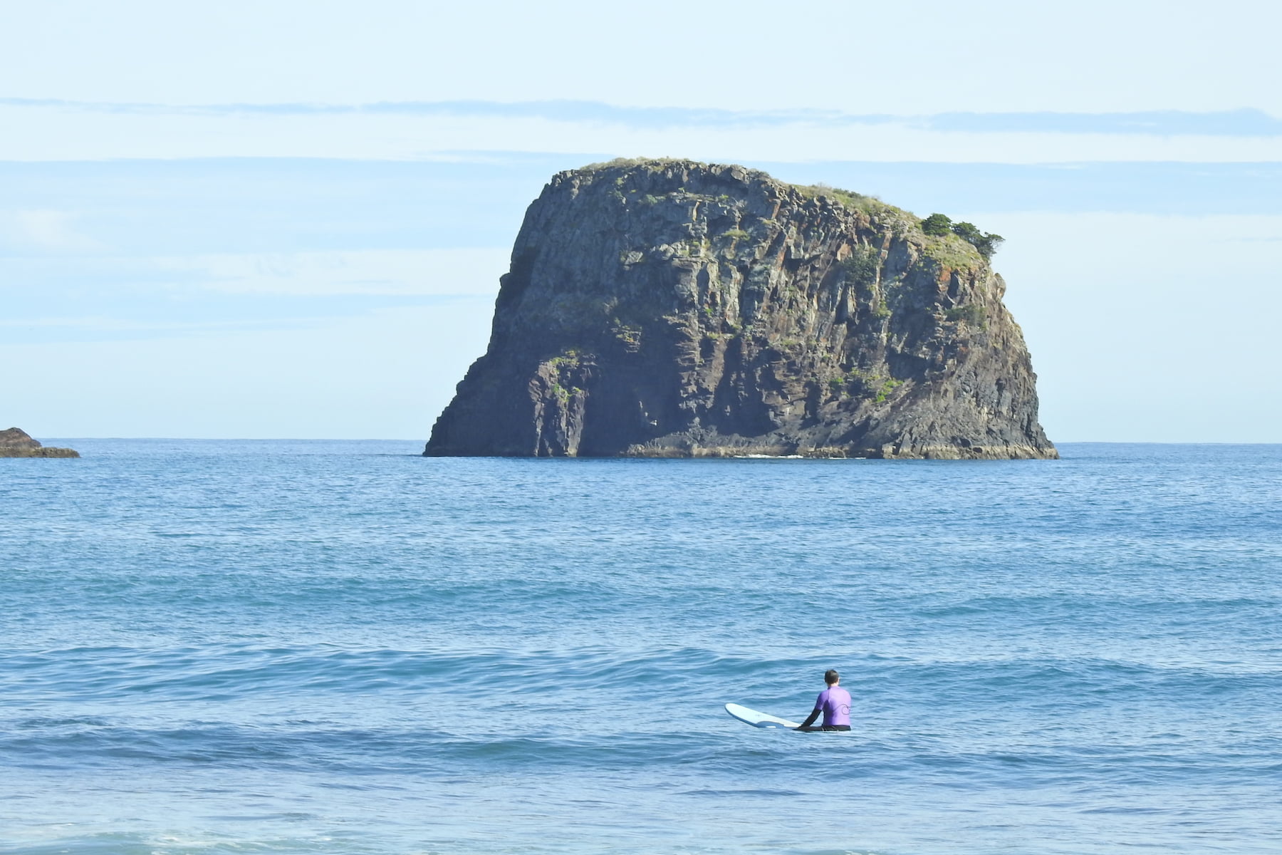 Surfer appreciating the view while in a surf guiding session in Porto da cruz