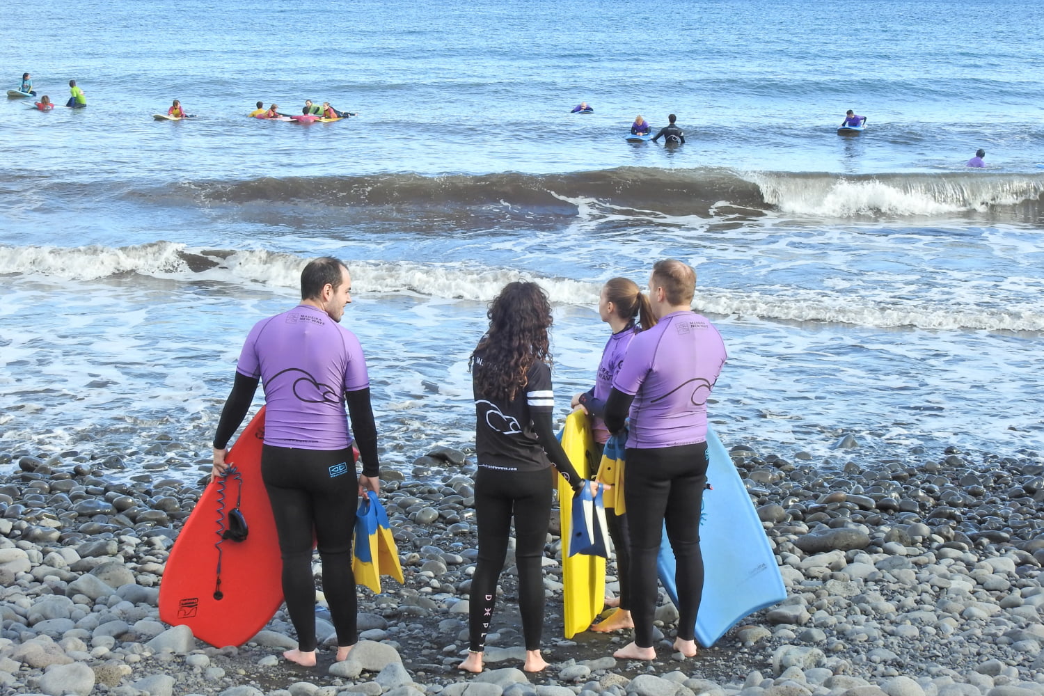 Group of bodyboarders preparing to start a private bodyboard lesson in madeira in machico's beach