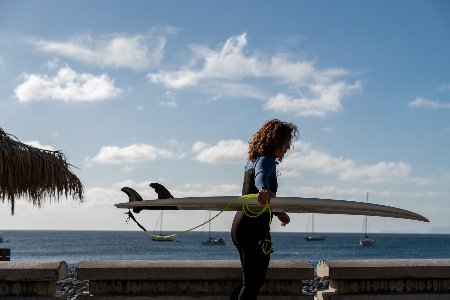 Female surfer with her surfboard preparing for a surf guiding session