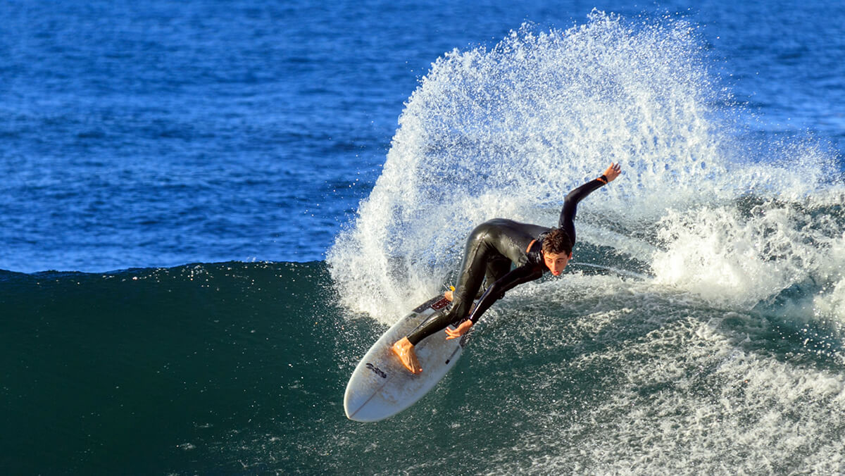 A surfer mastering a big wave in Porto da Cruz, Madeira
